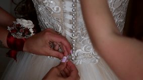 helps lace up the bride dress
