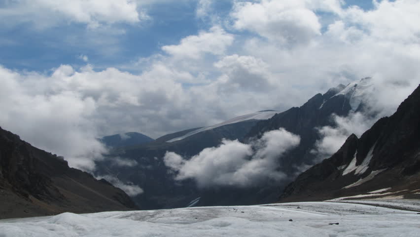 Timelapse landscape with white clouds and high mountain