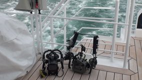 Camera for underwater video on yacht deck in Arctic Ocean. Extreme tourism and travel in the cold polar north. Scenic picturesque and blue water.