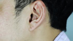 hd video of male put earphone into his ear for listening music
