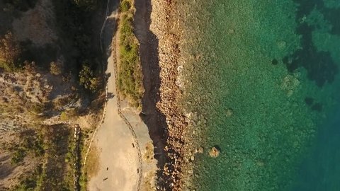 Aerial, calm flight top view of Elba shore with abandoned promenade
