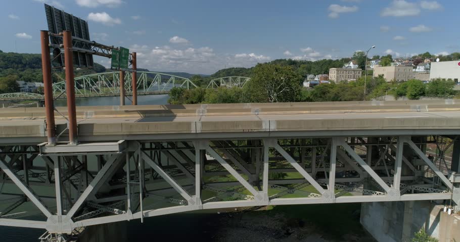 A daytime aerial profile perspective view of traffic passing over a bridge on Route 51 near Rochester, Pennsylvania.  	
