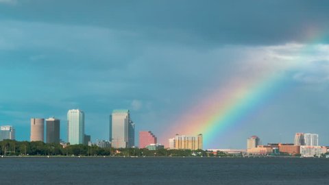Tampa, Florida skyline time-lapse with large rainbow above city 