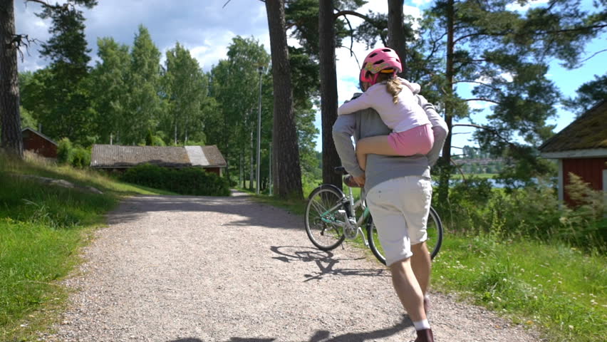 Caring Dad puts safety helmet on his little daughter