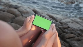 Slow motion chroma key display gadget in woman hands 1920X1080 HD video - Female on the beach holds green screen phone  slow-mo 1080p FullHD footage