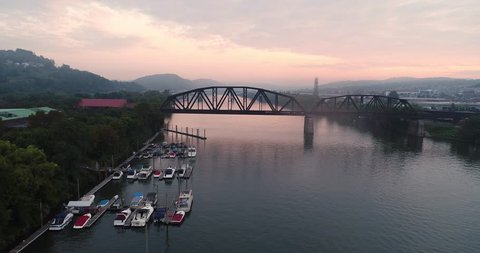 An early morning foggy aerial establishing shot of a marina on the Allegheny River outside of Pittsburgh, Pennsylvania.  	