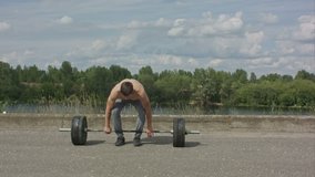 Bodybuilder doing barbell weight workout deadlift with heavy bar