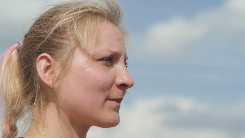 Female drinking a bottle of water after sport