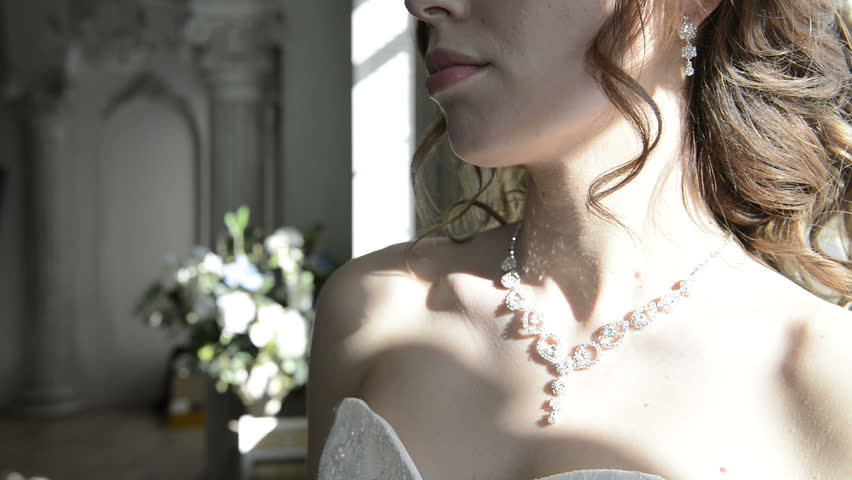 Bride in wedding dress posing in white vintage studio