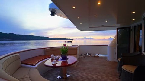 Luxury Yacht Beakfast on Stern with passing Long Tail Boat in Andaman Sea