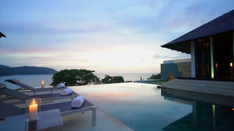 Evening twilight view from luxury pool deck infinity pool