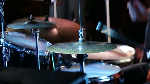 Rock drummer plays music on concert. Close up.