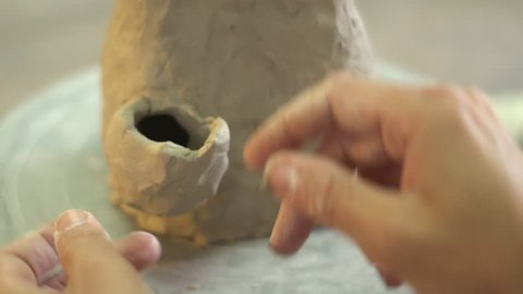 Potter sculpting a vase