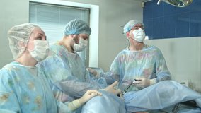 Team of doctors working together during a surgery in an operating room at a hospital