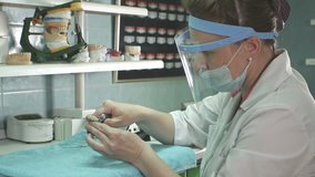 Dental technician making of denture in a dental lab