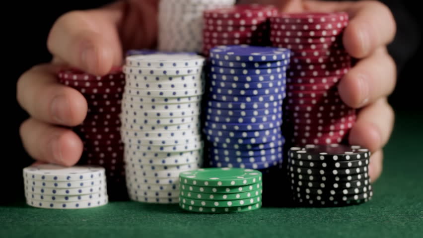 Pushing poker chips toward camera
