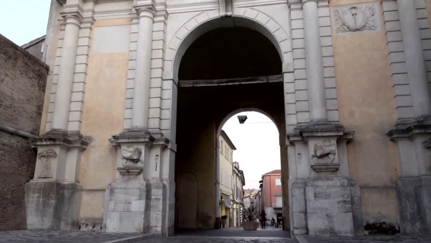 monumental door entry to main shopping street of Ravenna, Italy while darkening