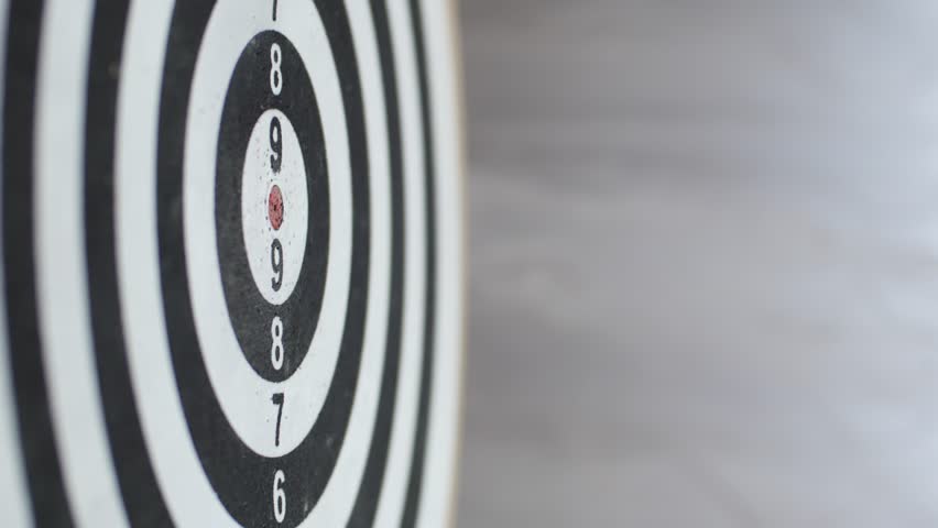 Close up of darts hitting the bulls eye on a dartboard Concept of successful business ideas hitting the exact center of the target. Perfect performance of the task and superiority over the rivals Royalty-Free Stock Footage #30829711