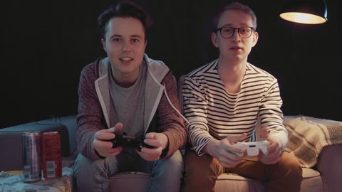 Two gamers in front of the screen are cutting in the online battle