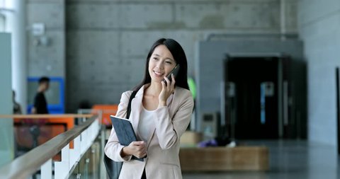 Business woman talk to cellphone and holding tablet computer 