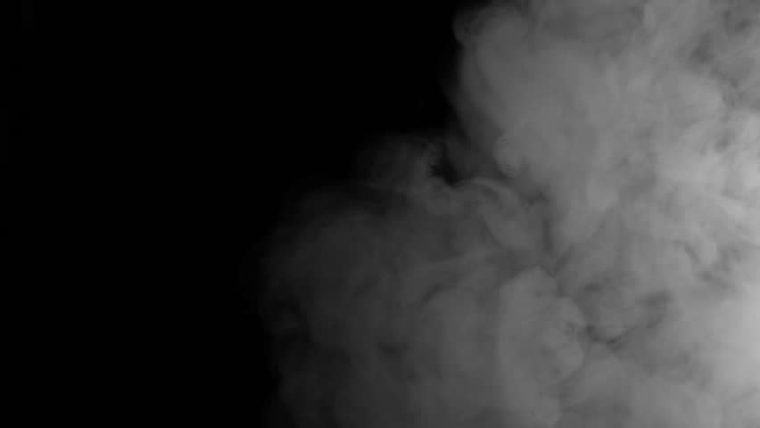 Slow motion moving smoke on the dark background. E-cigarette smoking at night. 