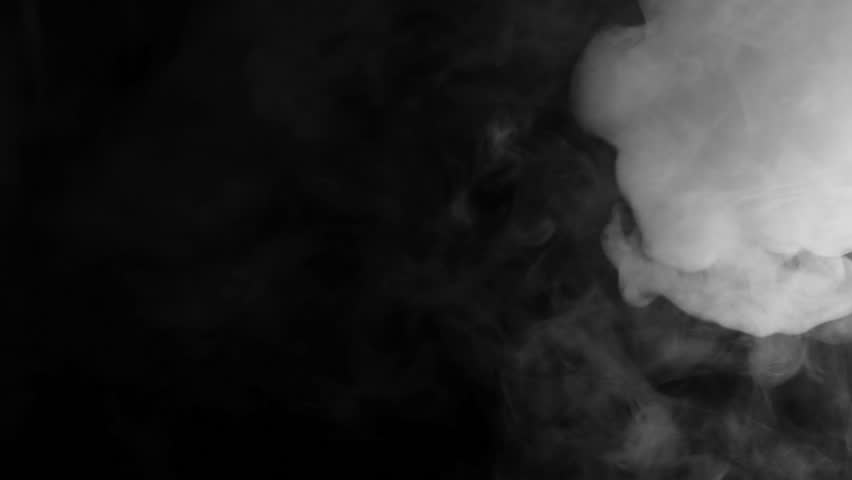 Slow motion moving smoke on the dark background. E-cigarette smoking at night. 