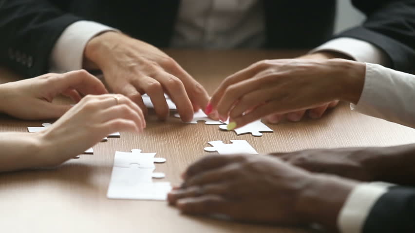 Multiracial business people hands unsuccessfully trying to assemble jigsaw puzzle at office table, team making incorrect decisions, finding wrong solutions in bad teamwork concept, close up view Royalty-Free Stock Footage #30832582