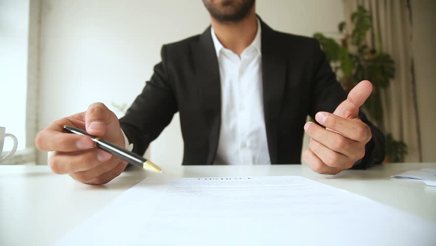 Businessman holding pen pointing on contract terms, negotiating explaining agreement conditions, offering to sign documents, giving official paper at camera to partner, proposing good deal, close up Royalty-Free Stock Footage #30832609