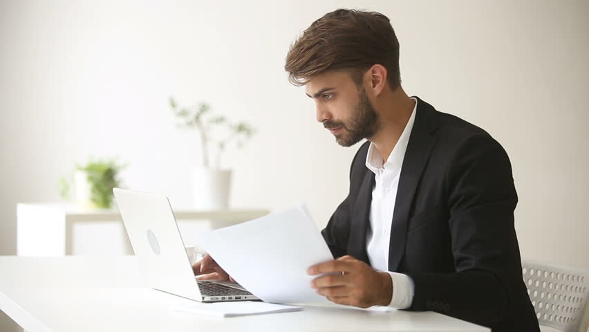 Young businessman wearing suit working with laptop documents sitting at office desk, financial analyst using accounting business app, economist analyzing statistics, trader smiling looking at camera Royalty-Free Stock Footage #30832636