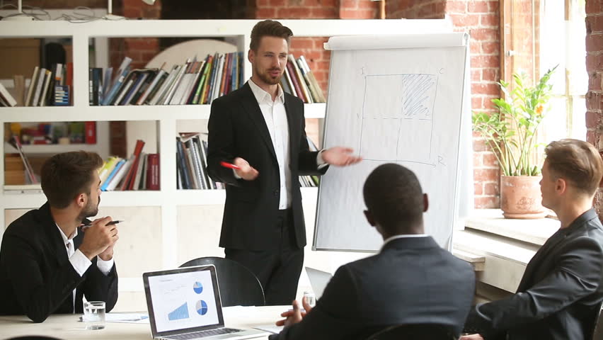 Businessman presenting new project to diverse partners with flip chart, team leader giving presentation to multiracial colleagues in boardroom, corporate business training, making offer to investors Royalty-Free Stock Footage #30832684