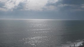 view from above on the sea. The sun is reflected in the small waves. The shimmering waves in the sun. No sound.