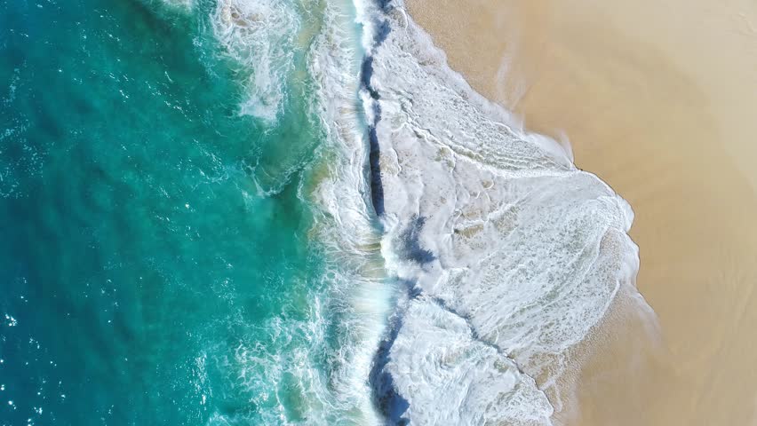 Aerial view waves break on white sand beach at sunset. Sea waves on the beautiful beach aerial view drone 4k shot. Royalty-Free Stock Footage #30842785