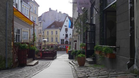 TALLINN, ESTONIA - AUGUST 20, 2017: Walking down the narrow street in the old town of Tallinn, Estonia
