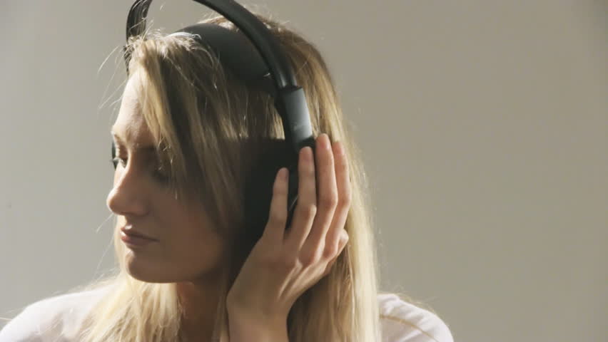 Beautiful woman listening to music on headphone