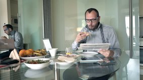 Young businessman eating breakfast and reading newspaper by table at home
 - Powered by Shutterstock - Get 15% off with code: PIKWIZARD15