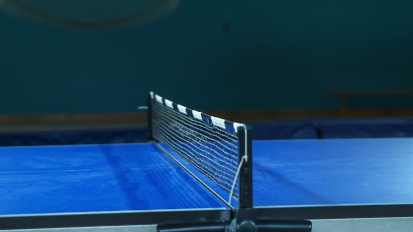 Kids are playing table tennis in a school gym. We can spot a quick game of the table tennis match and the movement of the yellow ball from one side of the table to another. - Powered by Shutterstock - Get 15% off with code: PIKWIZARD15