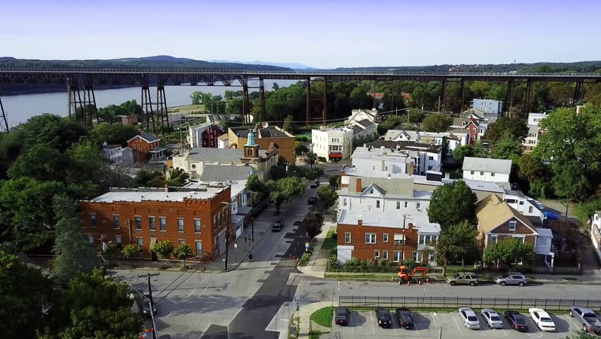  Little Italy, Poughkeepsie, NY clear afternoon light, 4k aerial establishing, walkway over the Hudson bridge.