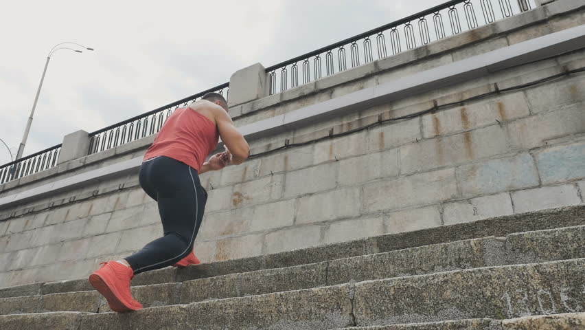 Young people at the embankment do sport
