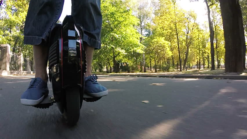 
Mono wheel, personal electrical transport in autumn city park. POV  view
