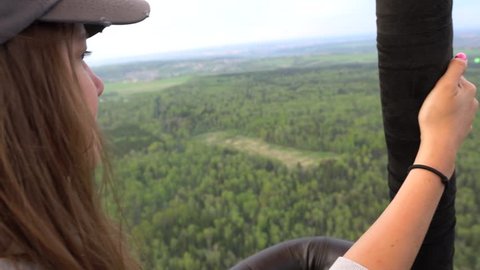 Flying over a green forest in hot air balloon busket. Handheld shot Arkivvideo