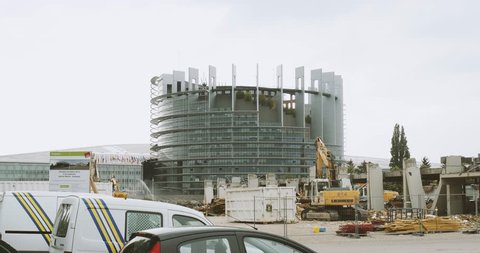 STRASBOURG, FRANCE - CIRCA 2016: Construction site with European Parliament Headquarter building in Strasbourg in the background with Liebherr excavator working