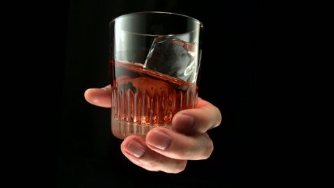Hand stirring a glass of drink shooting with high speed camera, phantom flex.