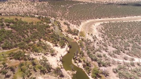 Aerial Helicopter view of dried up and drought affected Murray River Wetlands, lagoon, Billabongs and Swamps along River back water with only a trickle left.
