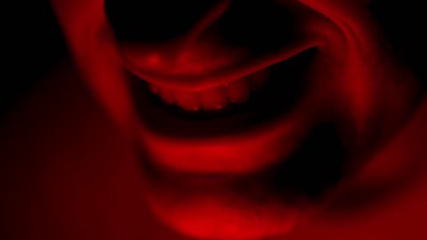 Creepy Weird Red Mouth Illuminated in Dark with Red Light