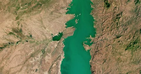 Very high-altitude overflight aerial of Cahora Bassa lake, Tete Province, Mozambique. Clip loops and is reversible. Elements of this image furnished by NASA