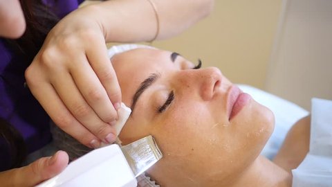 Face skin care. Woman getting facial ultrasound cleaning at beauty salon