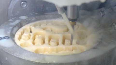 Works of the dental milling machine with water close-up. Processing of carving out shape of human teeth from dental milling machine. Modern medical technologies. 4.0 industrial revolution.