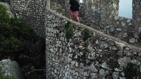 Climbing steps of Castle of the Moors Sintra, Portugal. Aerial footage running up a castle wall. 4k footage Pena National Park with castle in a forest. Fairytale castle video with a palace background.