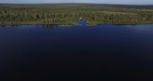 4K high quality aerial video of wilderness forest lakes at village Afonino, panorama and fishermen in boats near small town Pereslavl-Zalesski 100 km east of Moscow, Russia on bright summer morning