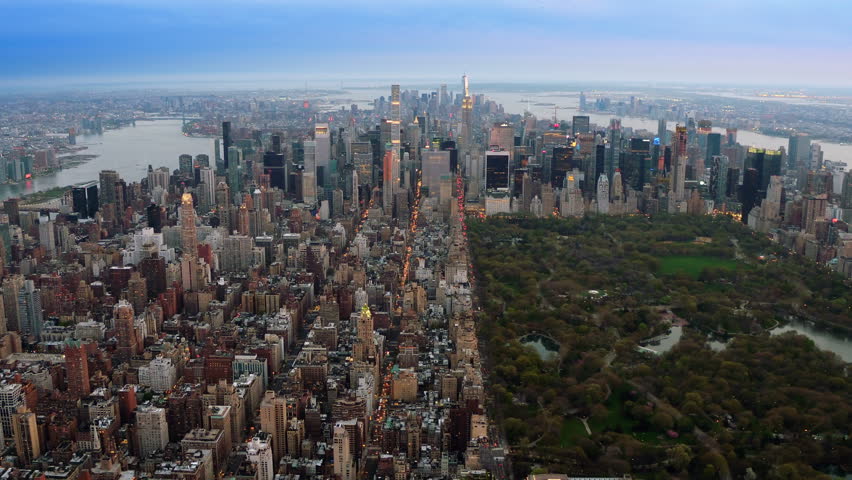 Beautiful aerial view of Central Park in Midtown Manhattan. Iconic skyscrapers as the Freedom Tower and the Empire State Building. New York City, United States. Shot from a helicopter.
